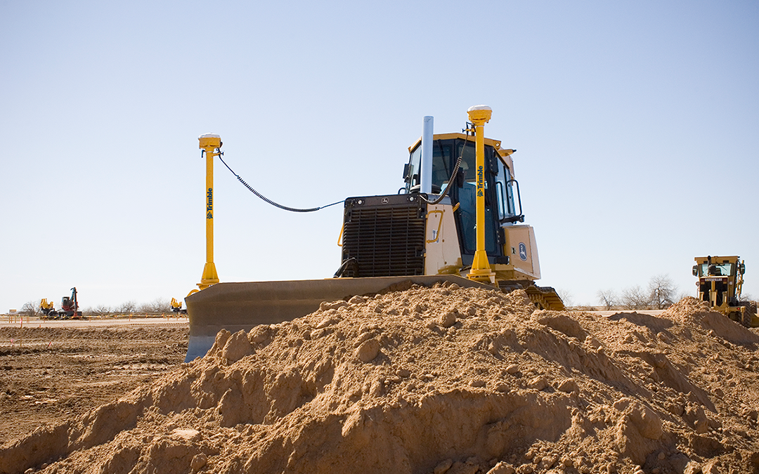 Dozer using site positioning solutions Trimble technology on a construction site. Solutions