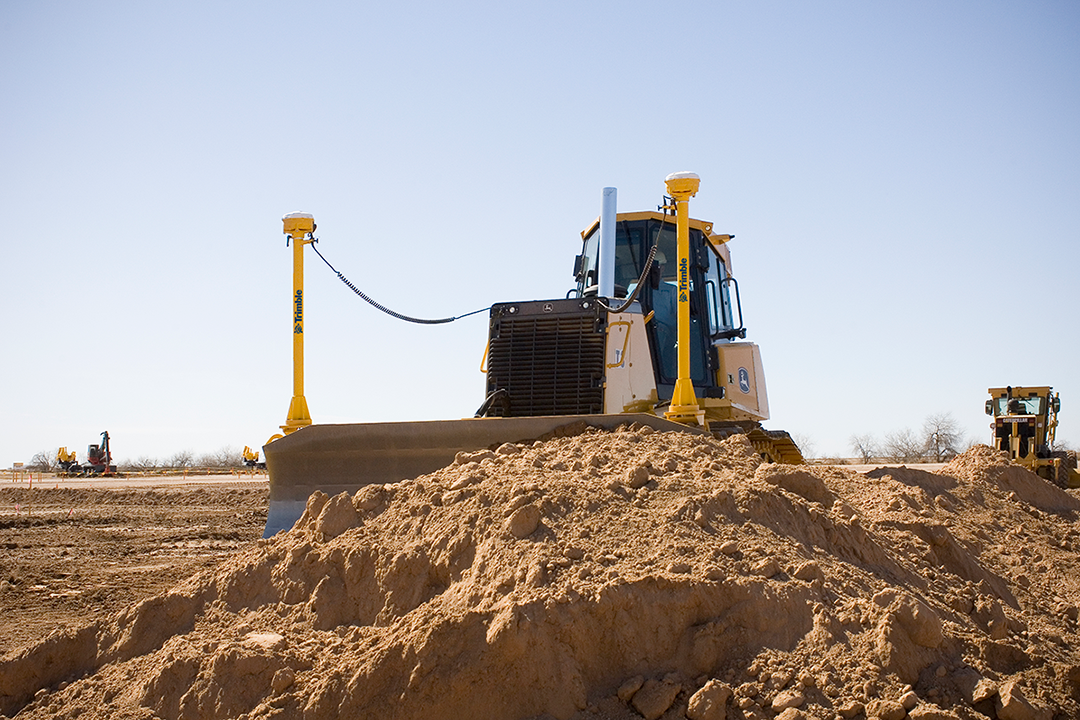 Dozer using site positioning solutions Trimble technology on a construction site. Solutions