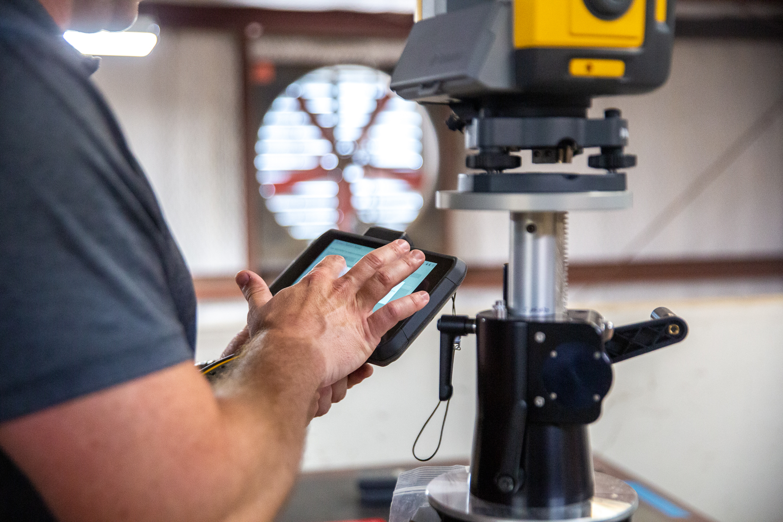 Sitech Louisiana employee demonstrating Trimble technology for construction solutions in the service room of Sitech Louisiana's warehouse. About