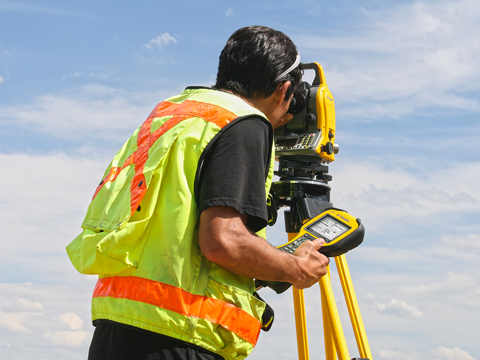 Construction working using Trimble TS635 total station. Maximizing Worksites with Trimble Solutions: A Comprehensive Guide